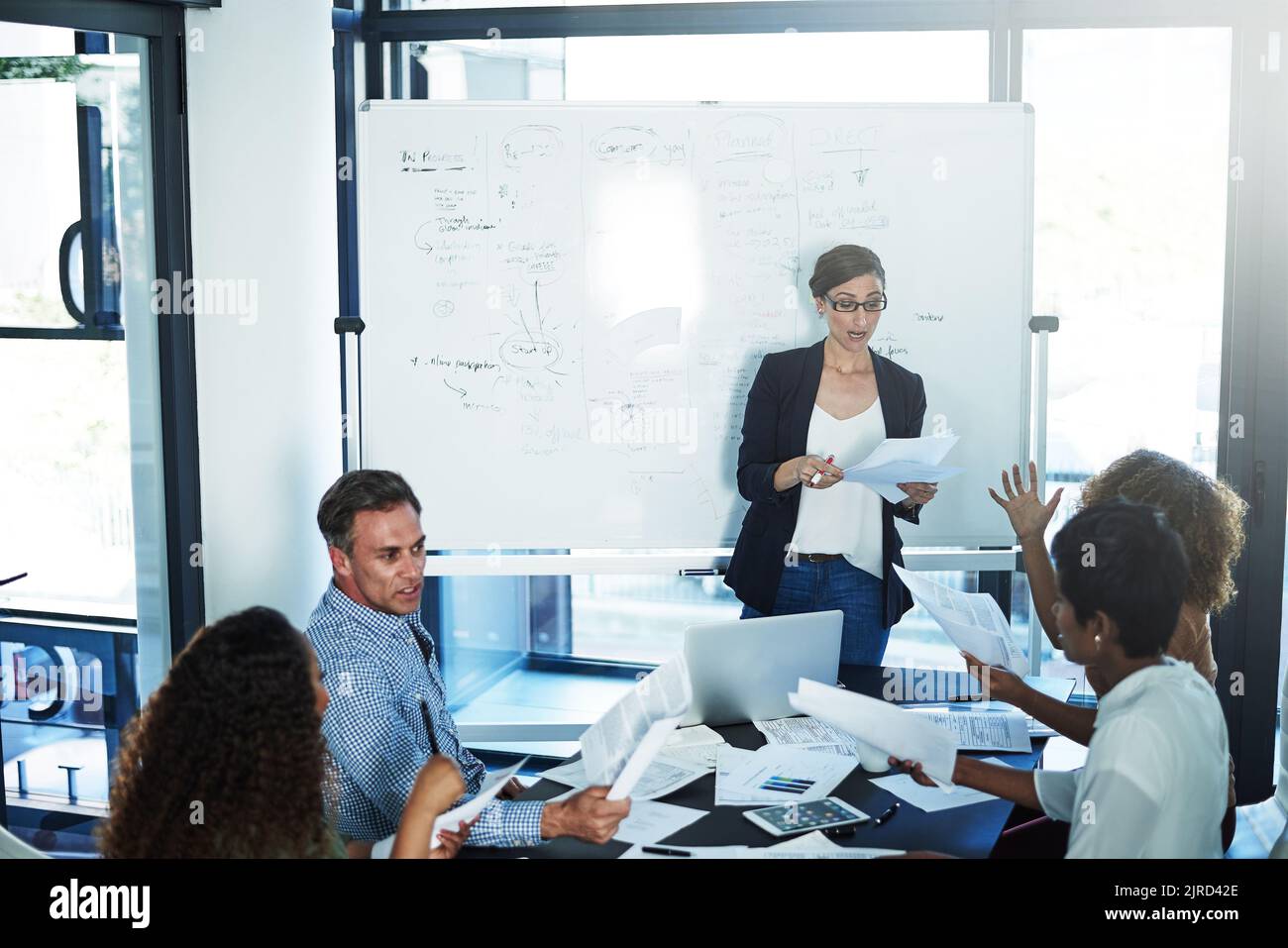 Caught Up In The Paperwork A Group Of Focussed Businesspeople Attending A Colleagues